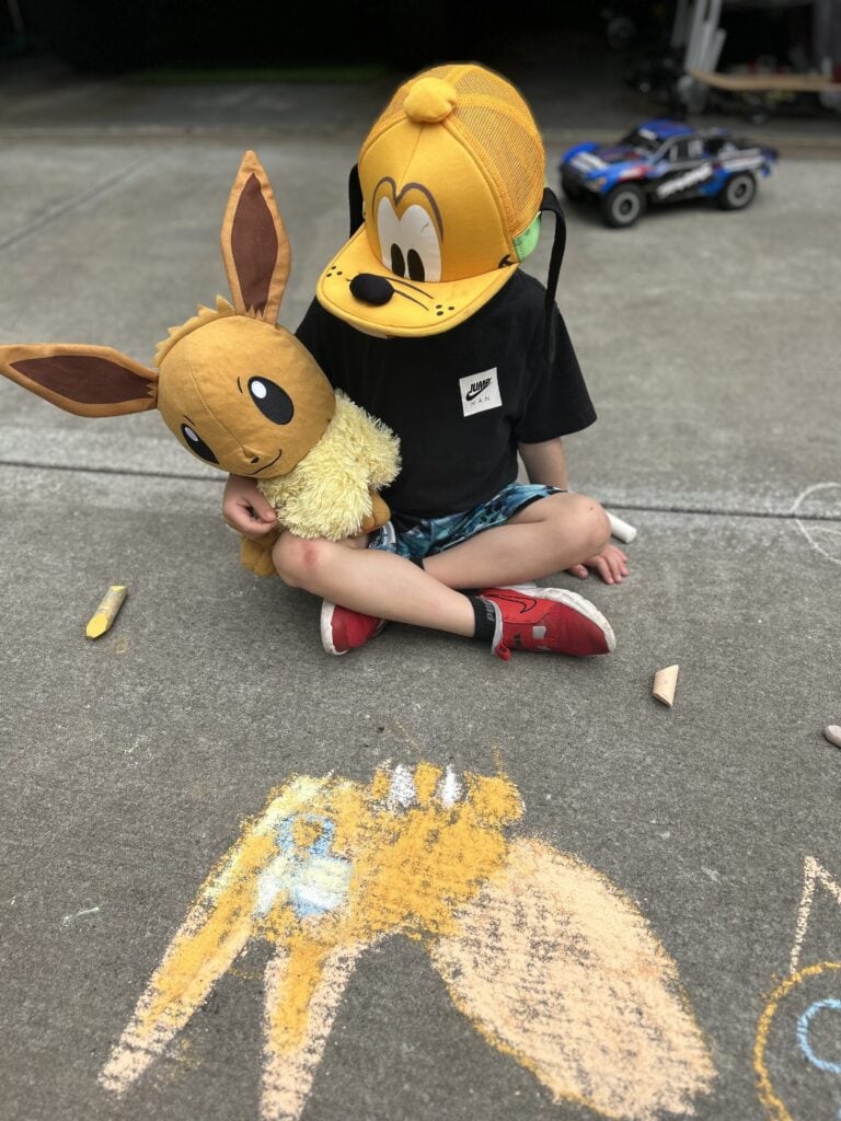 Child with Pluto hat on and Eevee a Pokémon favorite.  
